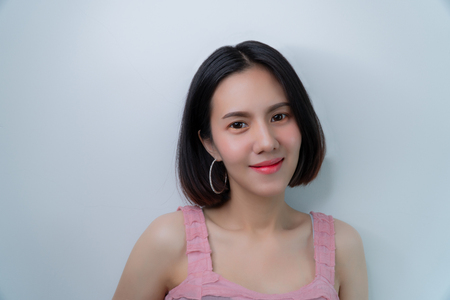 Portrait beautiful girl: A charming girl looks someone that can melt your heart. She looks so sexy and attractive. She has nice skin and beautiful face. She has a charming smile. Copy space.の写真素材