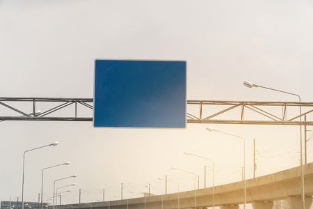 Blue overhead road sign with space to enter text. cloudy sky background. Copy space. の写真素材