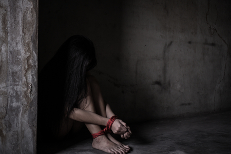 Victims of abducted women get wrists and feet in red. You have no way to fight or resist. She needs help. Hostage concept or female kidnapped from robber. Copy space. Dark Concepcion.の写真素材