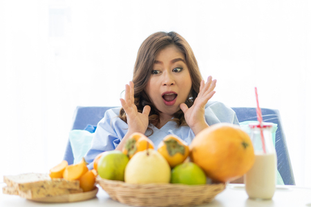 Women who have had rest breaks. She was awake with lots of healthy food. She was very happy. On a white background.の写真素材