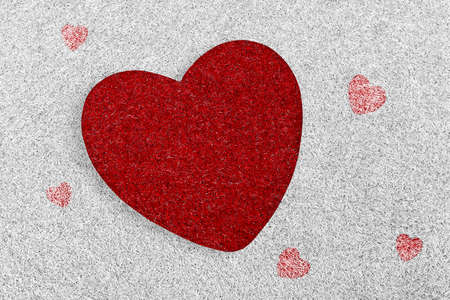 Red heart on white grass beautiful background for greeting card and wedding card decoration. Valentine's day concept.の写真素材