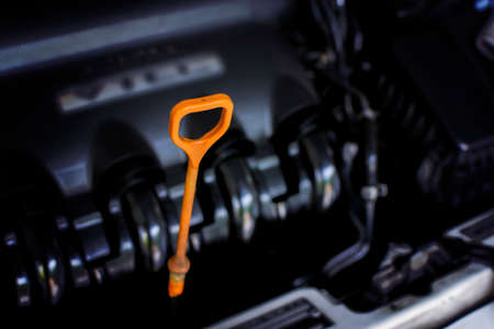 Oil level gauge with orange color for Checking engine oil level. selective focus.の写真素材