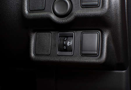 Headlight level switch on a panel of car for headlight level adjustment control, automotive part...