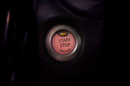 Engine start button of car with a orange light, automotive part concept.の写真素材