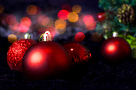 Christmas holiday with red balls shiny decorated on bokeh blurred background.