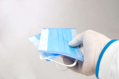 The medical mask in the hand of the doctor use for prevention germs,Coronavirus,Covid-19.
