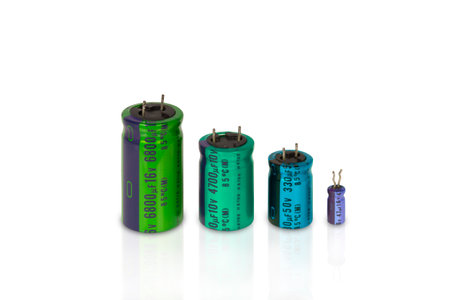 Electrolytic capacitors row with multi colors on a white background