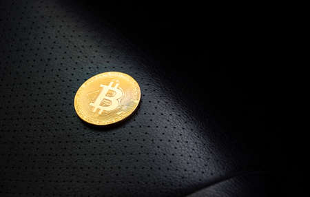 Golden bitcoin placed on the leather seat with black copy space this right, Cryptocurrency virtual money and blockchain technology conceptの写真素材