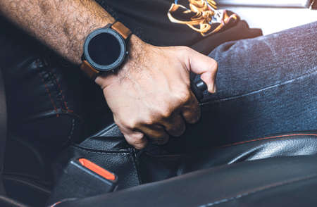 Car driver pulling handbrake lever in the car on the parkingの写真素材