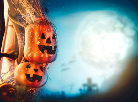 Halloween pumpkin and graveyard blurred background in the full moon night with copy space,halloween celebration conceptの写真素材