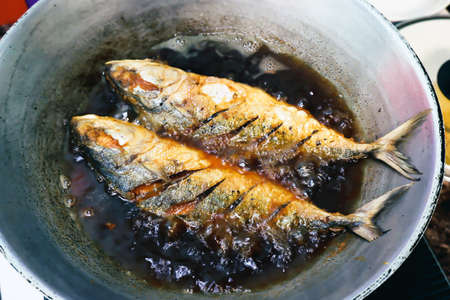 Salted fish fry in a pan with cooking oil, Thai style food conceptの写真素材