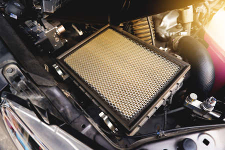 Car air filter on the air filter slot in the car engine system with a sunlight, Automotive parts conceptの写真素材