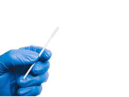 Cotton swab in a medical hand isolated on white background with copy space,conceptの写真素材