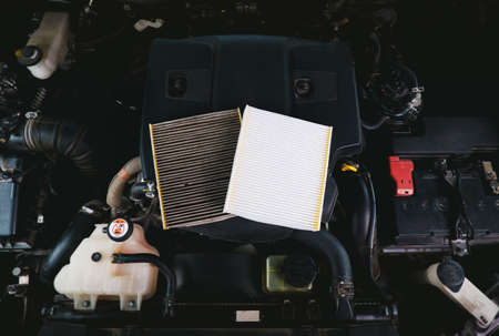 New air filter and old filthy filter for compares placed on the car engineの写真素材