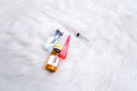 Monkeypox and smallpox virus vaccine bottle (MPXV) ,medicine ampoule and syringe on white rug...