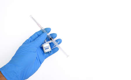Monkeypox and smallpox virus vaccine bottle (MPXV) and syringe in a medical personnel hand with...