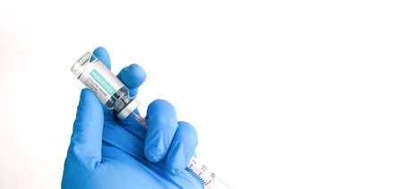 A doctor hand fills a syringe with monkeypox and a smallpox vaccine from a bottle, object isolated...