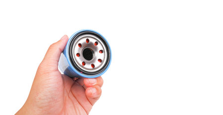 Automotive oil filter in a hand , object isolated with clipping path and copy space on white...