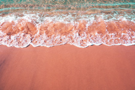 Aerial view of a sandy beach with waves breaking on the shore with copy space below, Travel and vacation conceptの写真素材
