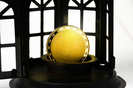 Blank gold coins in a metal pedestal with a black window on a white background.の写真素材