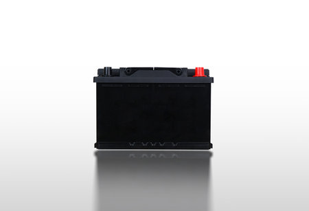 Closeup in front of car battery isolated on white background with reflection, clipping path included.の写真素材