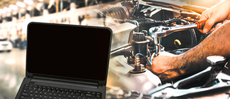Car maintenance service concept, Blank laptop black screen and auto mechanic in the auto repair shop, Double exposure.の写真素材