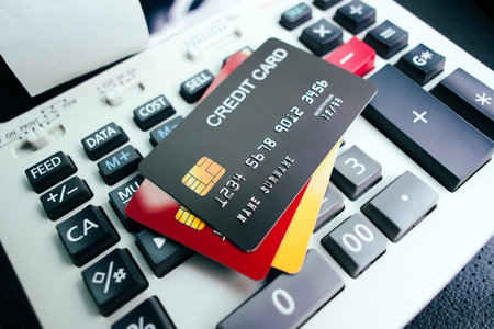 Credit card and calculator on the table. Several credit cards placed on the printing calculators....