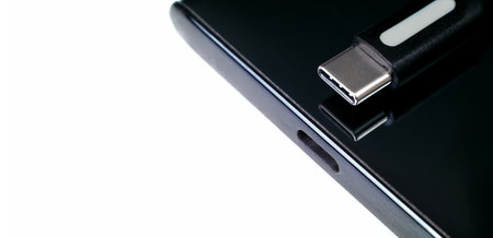 USB Type C cable, Type-C port connector on white background, power charger port of mobile phone, panoramic banner with copy space for text, smartphone charger technology concept.の写真素材