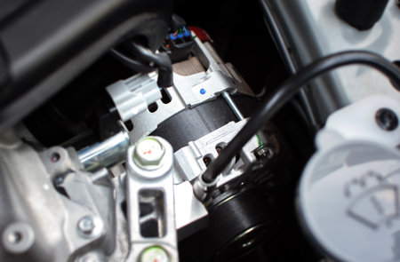 Close up of car generator or alternator in engine compartment, car spare parts concept