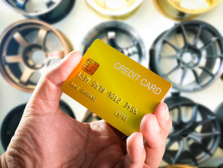Buying car wheels with credit card in hand , Credit card and loan service conceptsの写真素材