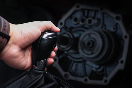 Close up of driver hand changing gears , Automatic gearshift lever and transmission with blurred...