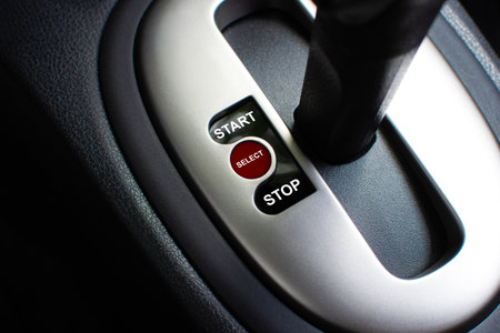 Selector Switch Lever, A close-up of a car gear shift console with START, SELECT, and STOP buttons....