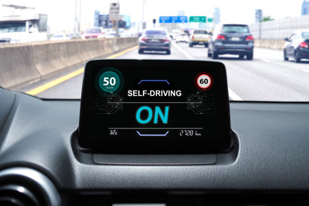 Self-driving car dashboard display with speed limit alert and active autonomous driving mode on...
