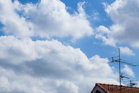 antenna tv with clouds in the blue skyの写真素材