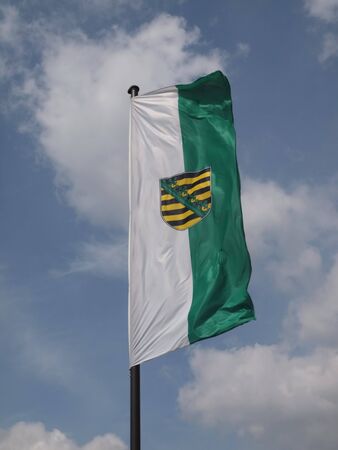 Flag of the Free State of Saxony in the windの写真素材