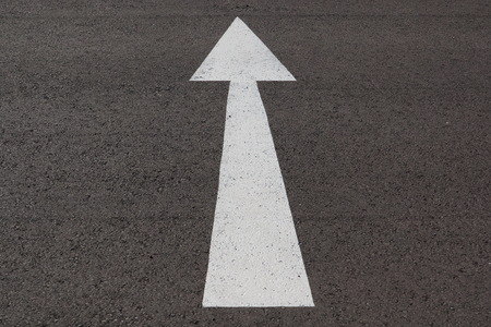 Road marking arrow on asphaltの写真素材