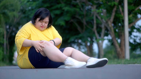 Asian girl with Down syndrome knee injury.While exercising in the park.の写真素材