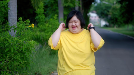 Asian woman with Down's syndrome is happy to imagine her crossing the finish line.の写真素材
