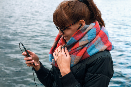 pretty young girl chatting with a friend on the phoneの写真素材