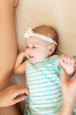 a little baby girl plays with motherの写真素材