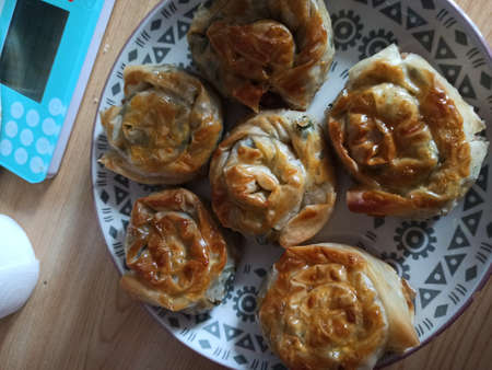 Turkish style pastry made by grandmother. Freshly baked pastry. Oven baked products. Spinach filled borek.の写真素材