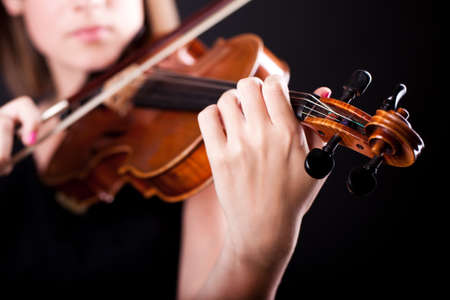 Woman with the violin focused on violinの写真素材