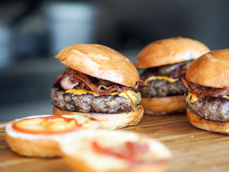 Close up of a hamburger with side dishes on a plate.の写真素材