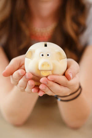 Money, finance. Girl with piggy