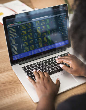 Close up of a womans hands typing on the laptop