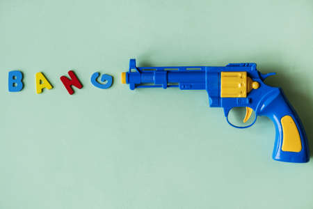 Flat lay of the text BANG depicted as being fired from a toy gunの写真素材