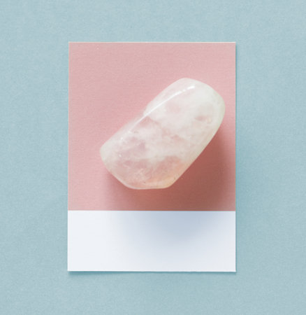 Flat lay of an unpolished stone on spaced cardboard frameの写真素材