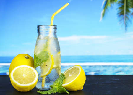 Close up of chilled lemonade in a bottle with yellow strawの写真素材