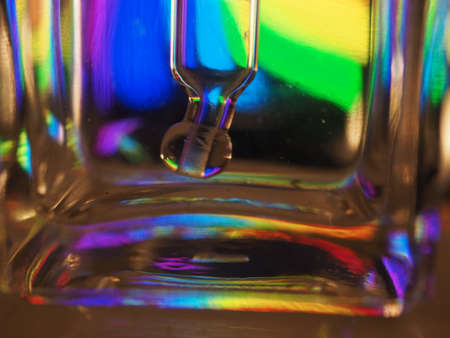 rainbow colored reflections in a liquid glass