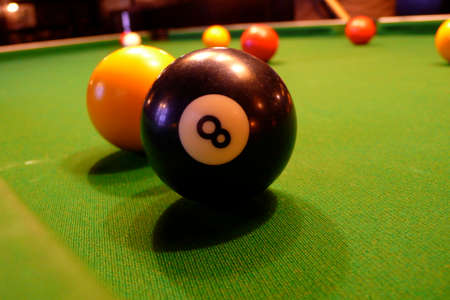 eight pool ball on a green table